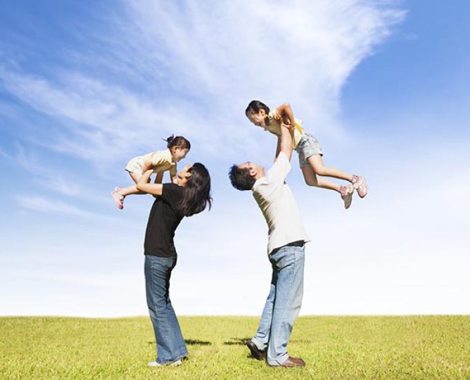 happy family on the grass with cloud background